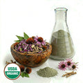 Echinacea flowers and dried plant parts  in a bowl with a glass flash of powder, flowers, and sticks on a white background with the USDA Organic logo.
