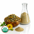Swamp flowers and stems in a wooden bowl and glass flask container with a yellow flower and USDA Organic label.
