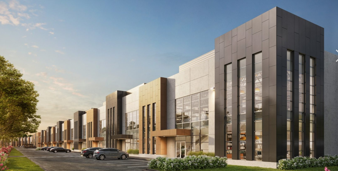 Modern commercial buildings with cars parked along a street