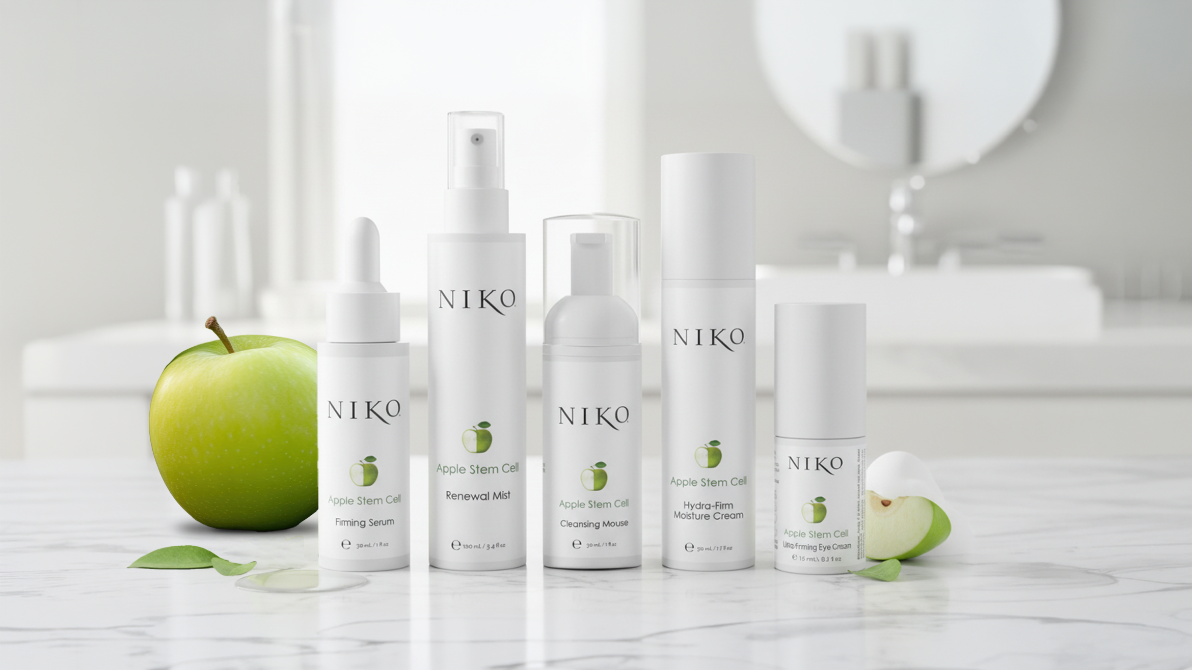 Apple Stem Cell collection of five products on a white bathroom style setting, a green apple behind on the left and apple slice on the right.