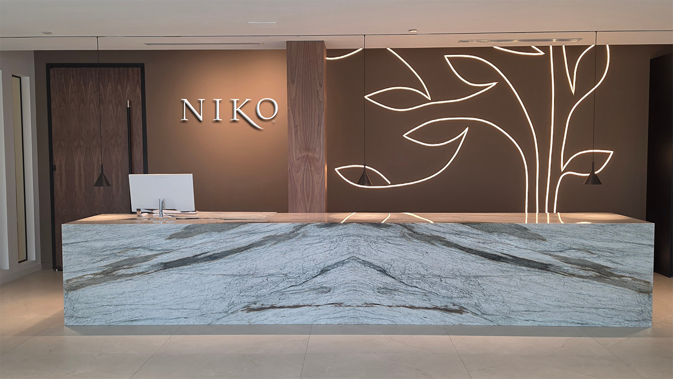 Modern reception desk with marble finish in a stylish interior setting, featuring the brand 'NIKO'.