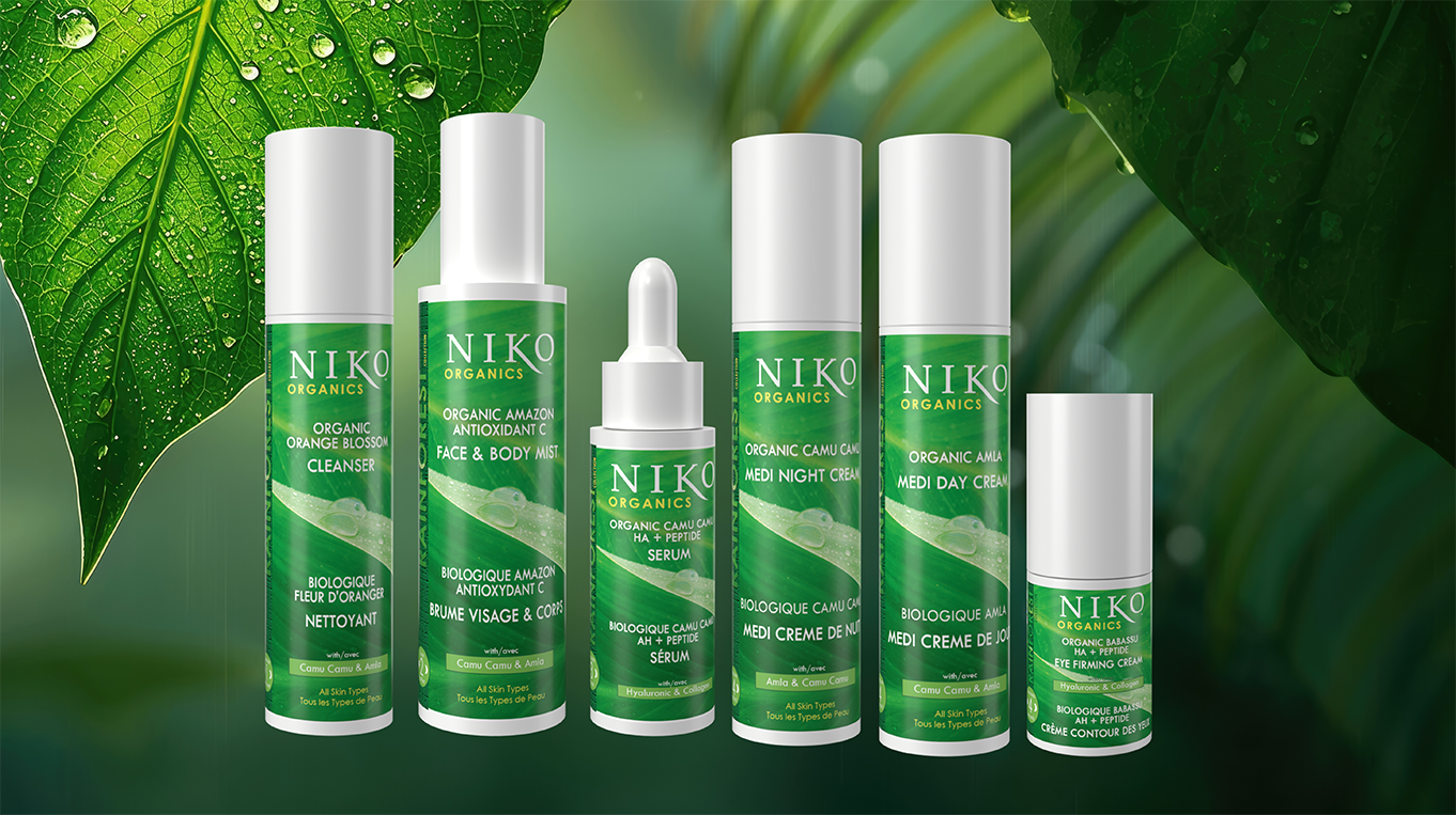 Rainforest collection of 5 productsn lined up on a green surgace with large tropical leaves in the background.